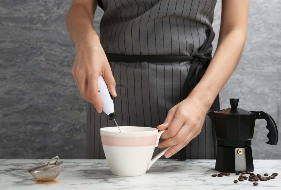 using a hand want milk frother