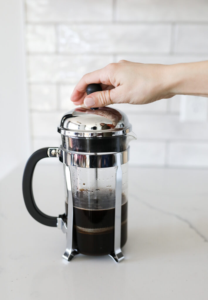 pressing down french press coffee