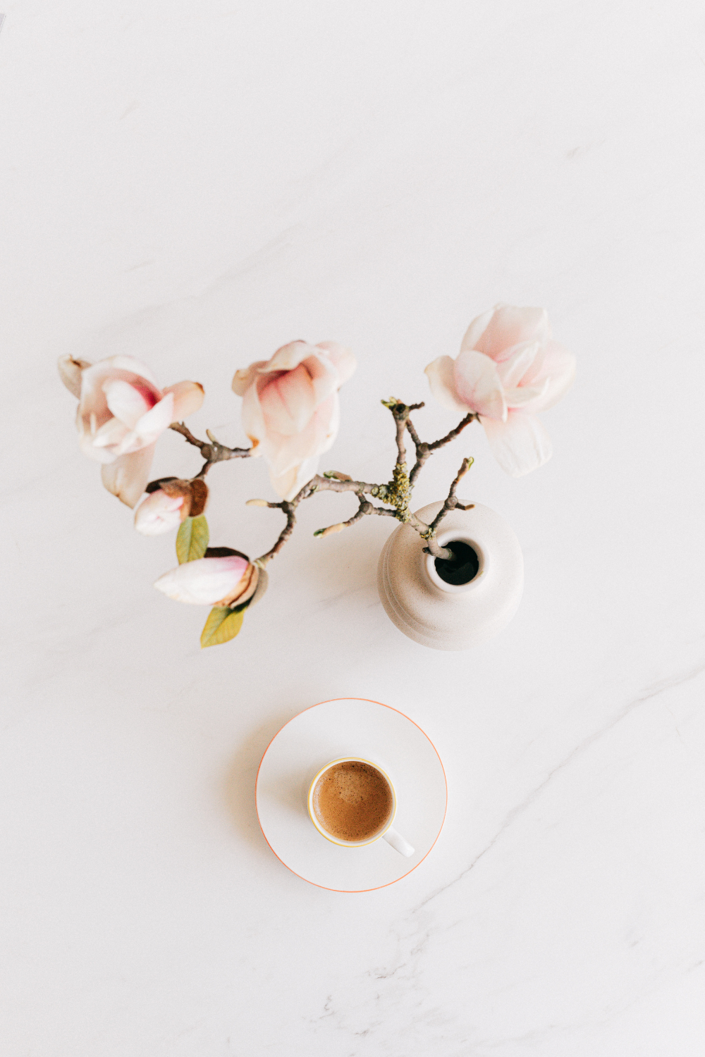 Cup of espresso next to a vase 