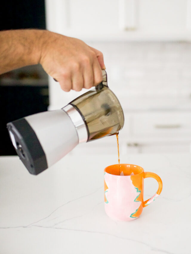 pouring coffee from a moka pot into a colorful mug