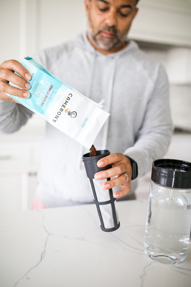 pouring coffee beans into cold brew filter