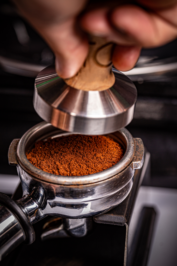 spreading out espresso and forming a puck