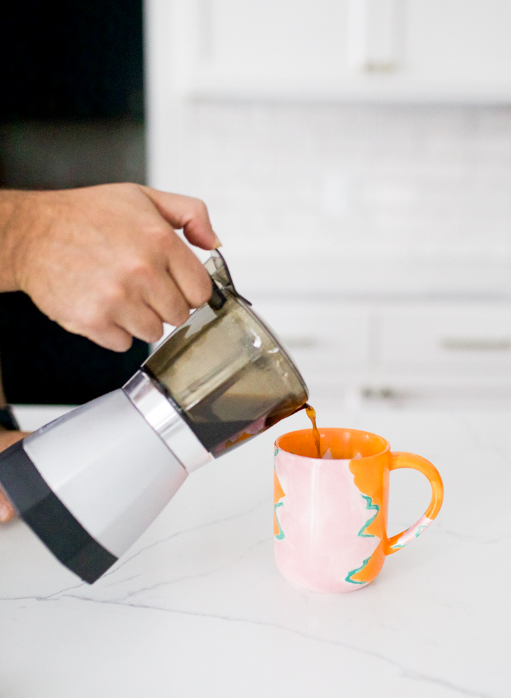 pouring coffee from an electric moka pot