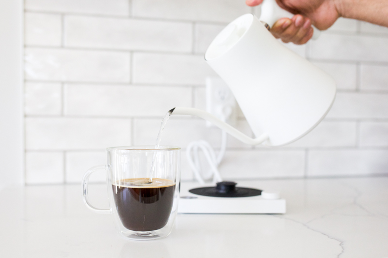 adding water to espresso making an americano