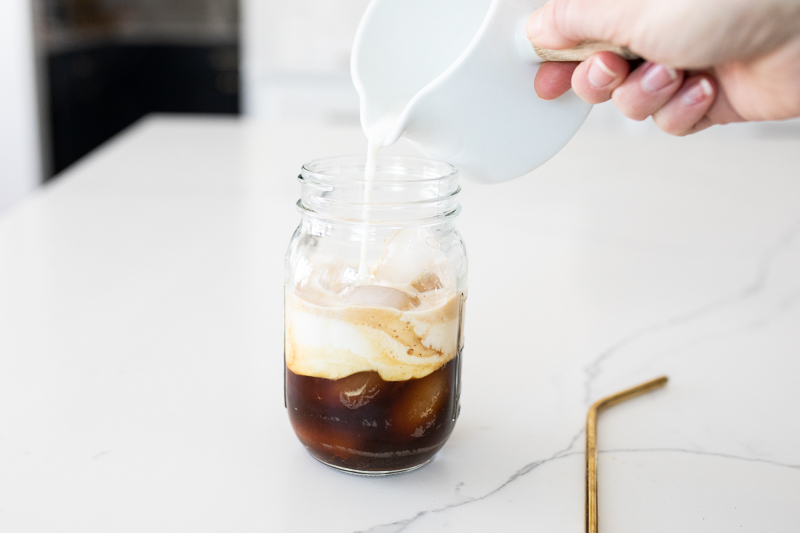 pouring milk into shaken espresso drink