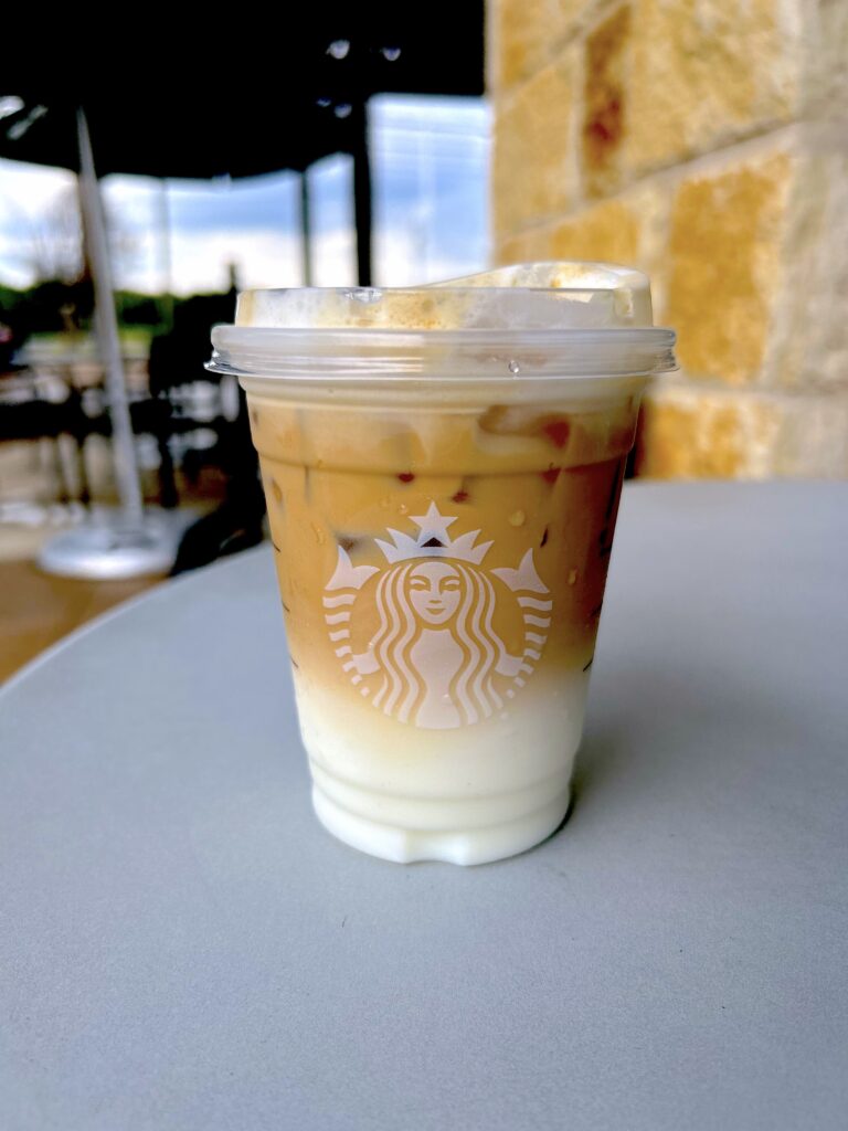 Iced Caramel Cloud Macchiato on a table 