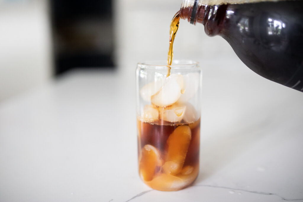 Pouring cold brew into a glass